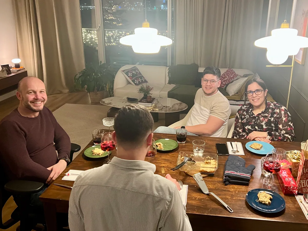 Friends gathered around the table for dinner at home